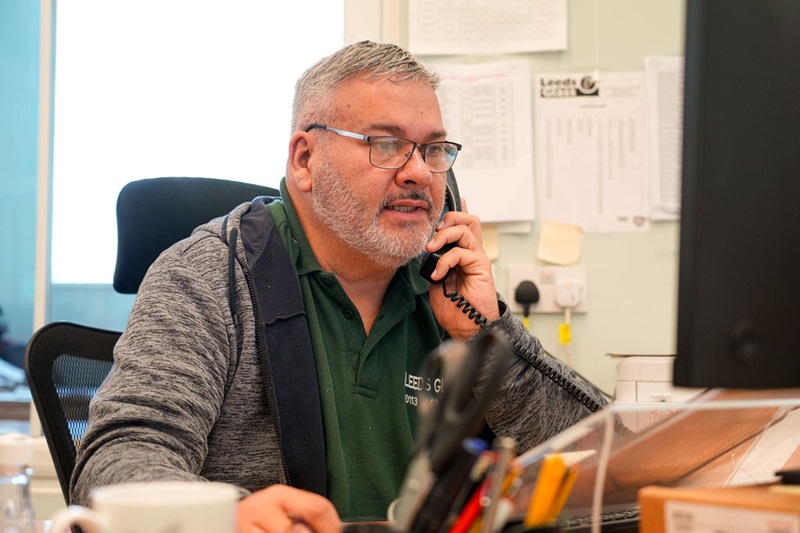 Leeds Glass team member on a customer call about commercial glazing