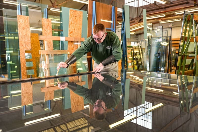 Leeds Glass technician preparing a large commercial glazing panel in the workshop